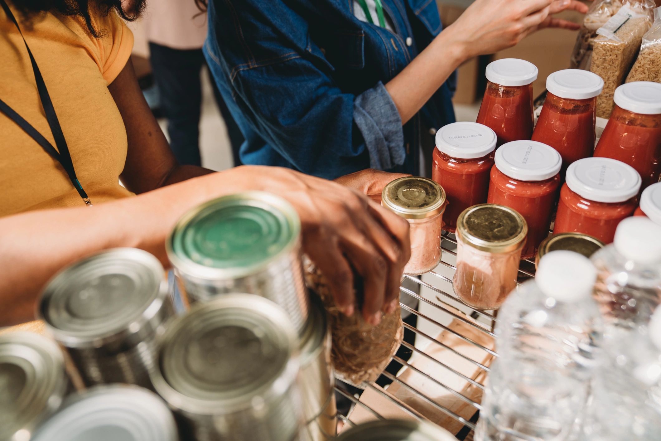 Volunteers organizing food and supplies on shelves